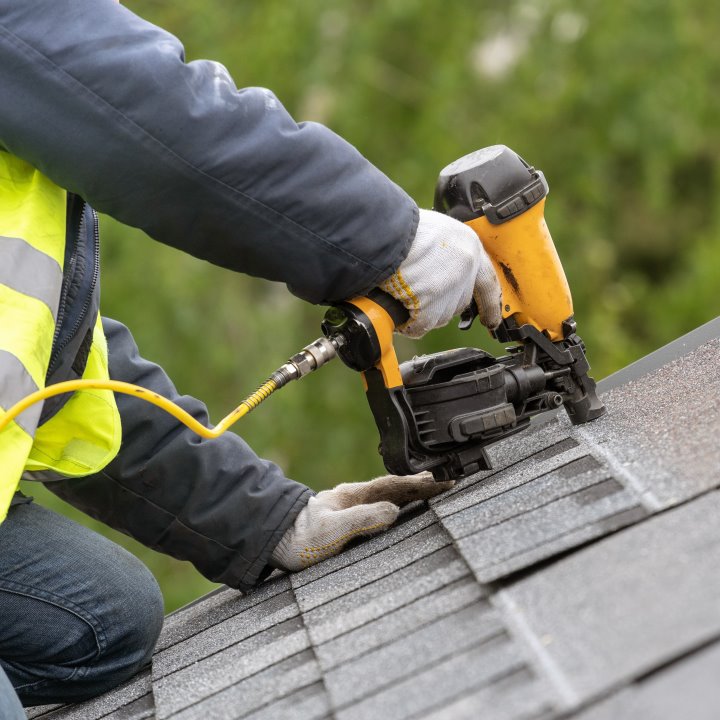 Residential asphalt roof being repaired